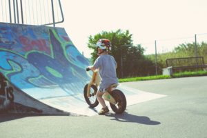 Risk-averse parenting? Young child wearing a helmet on a bike